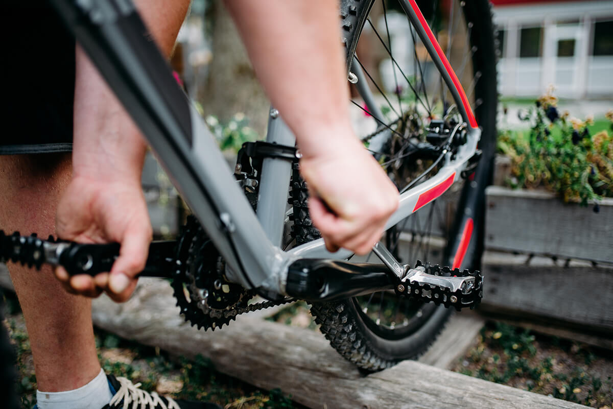 person taking off bike pedals