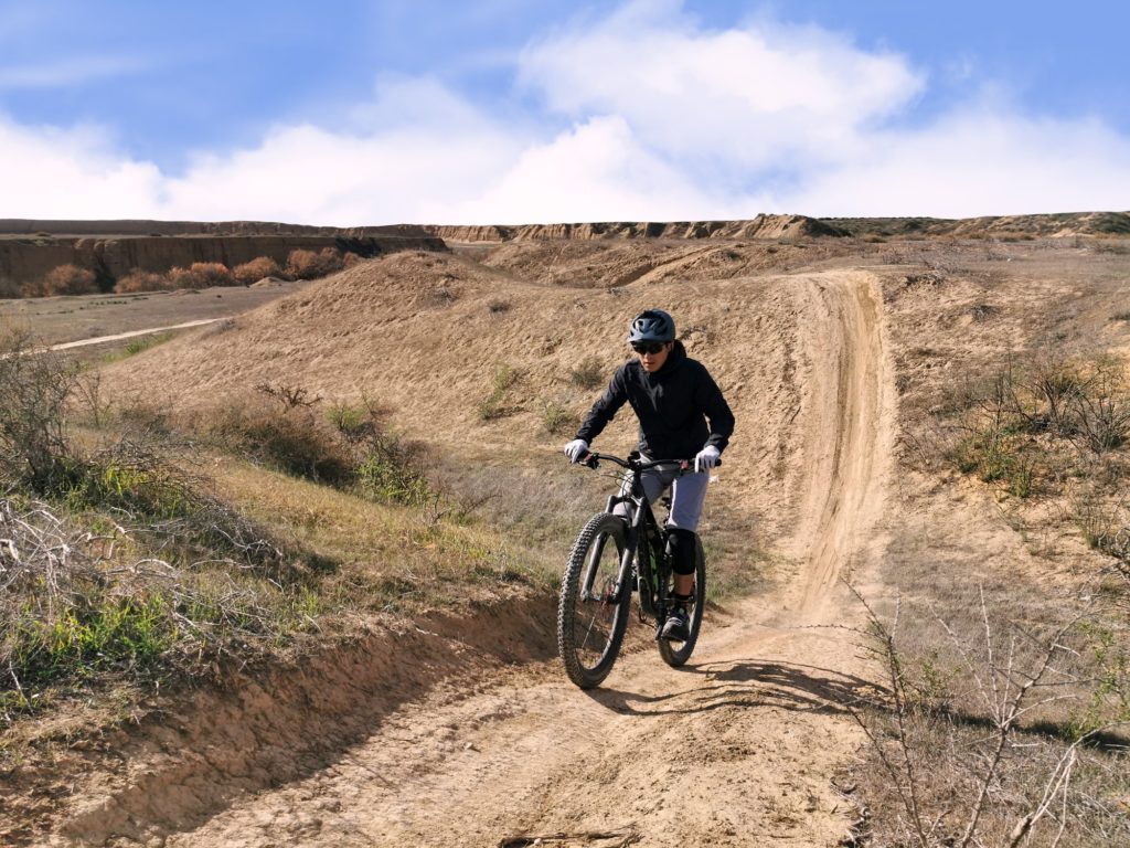 man biking on dirt road
