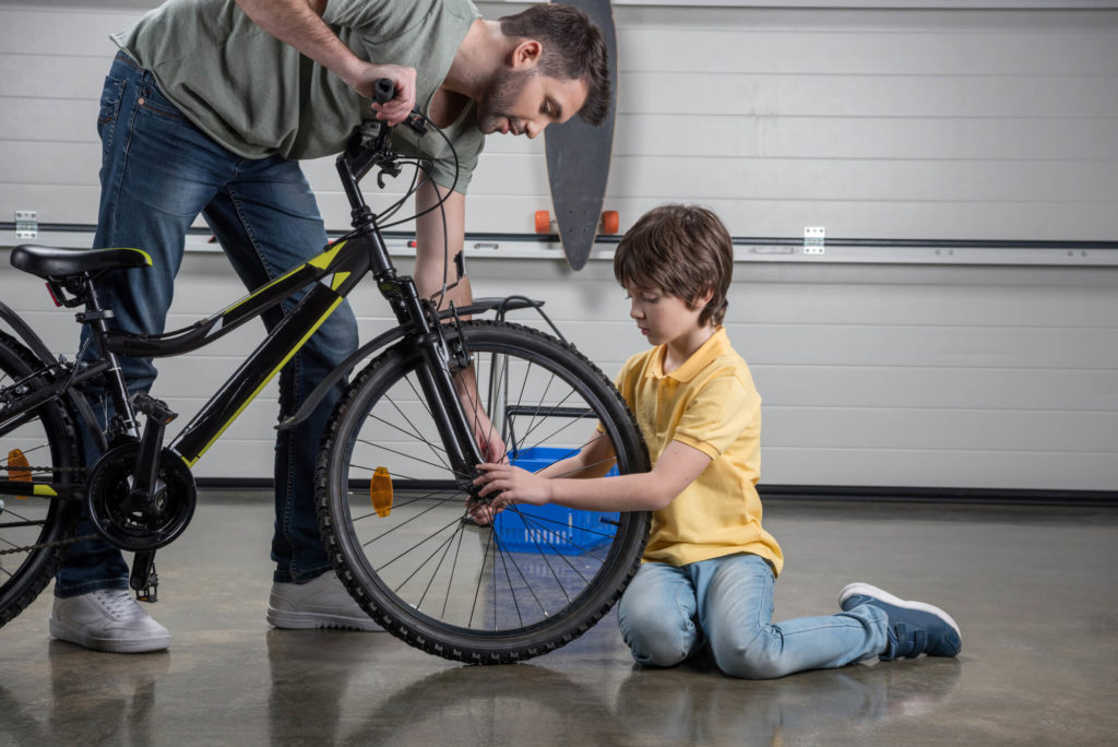 father and son working on bike