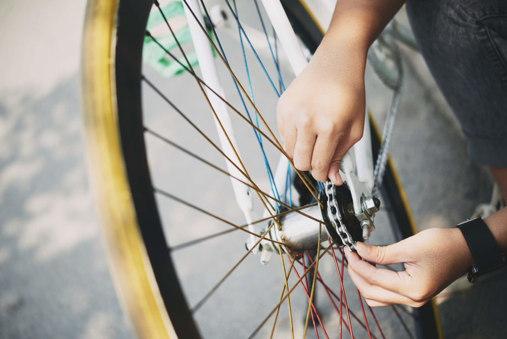 man checking bicycle chains