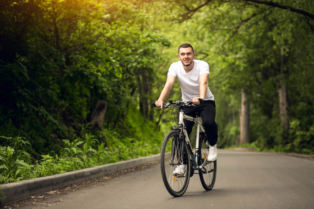 man cycling on asphalt