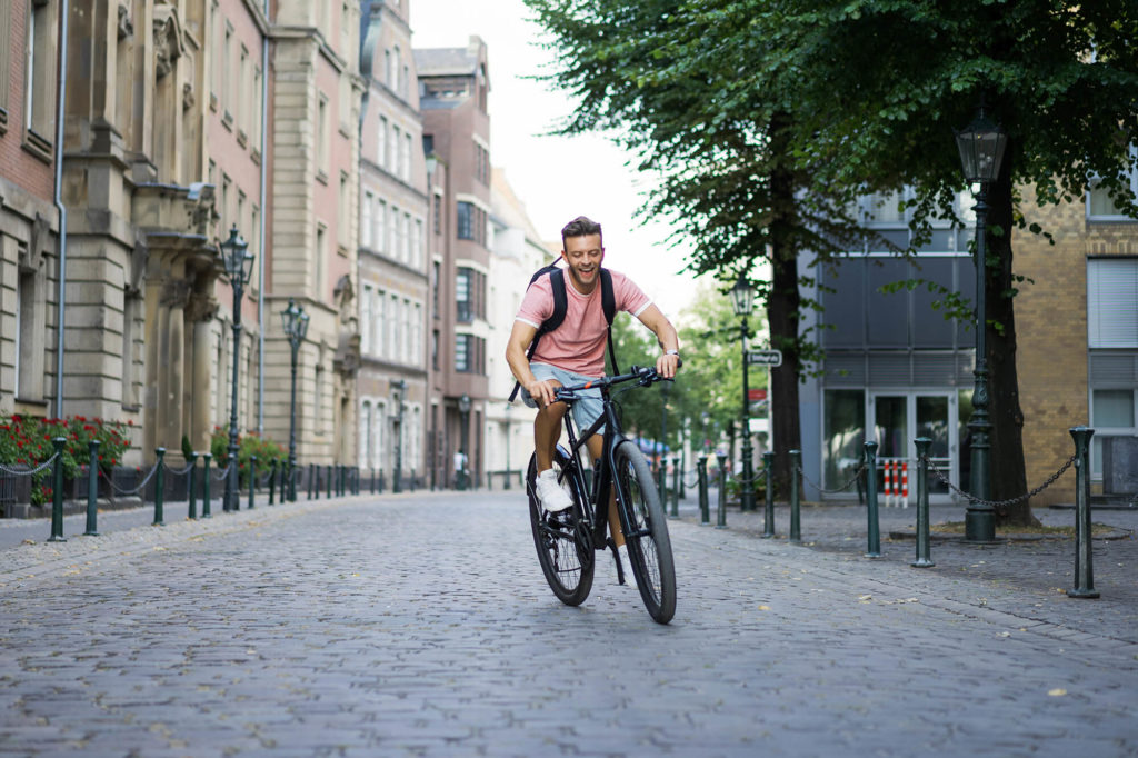 man riding bike in city center