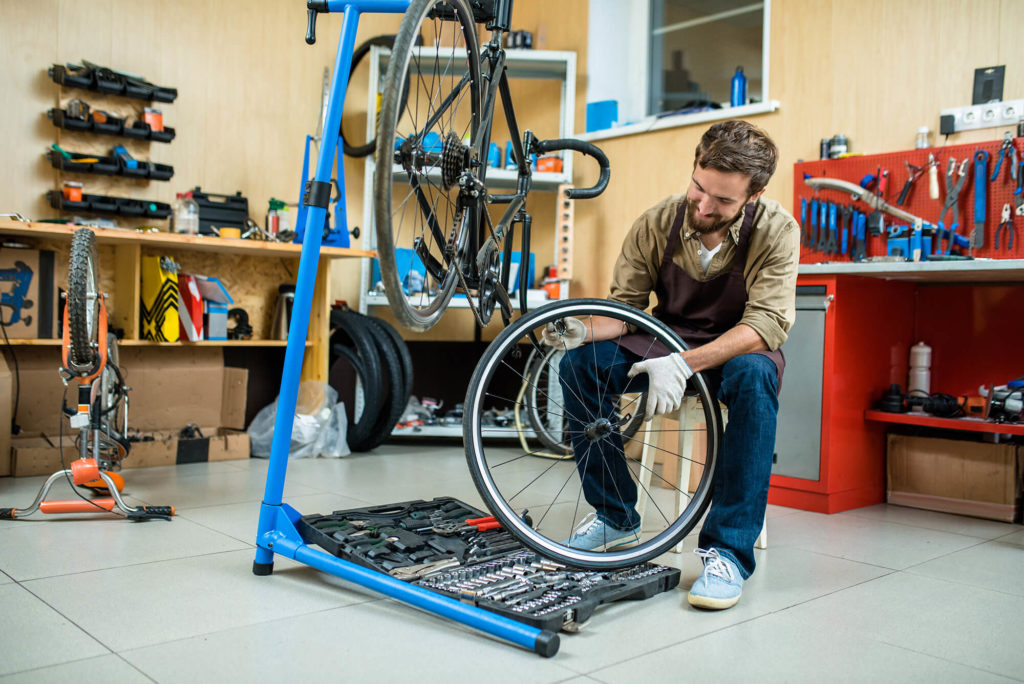 man working on bike in garage