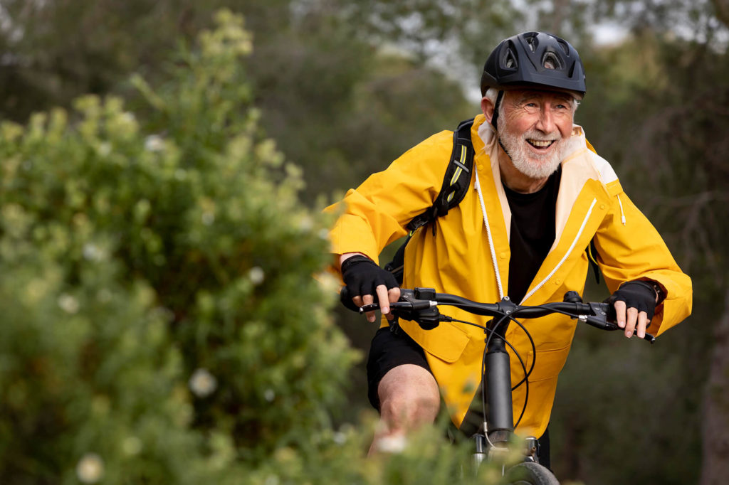 senior man exercising on bike