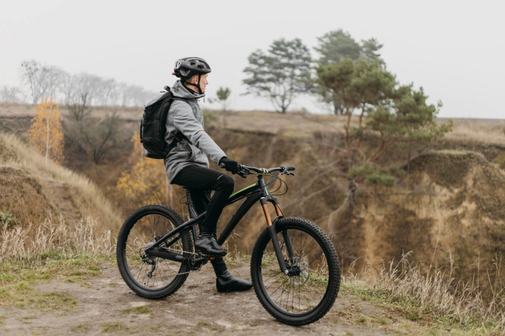 man taking a break from riding a mountan bike